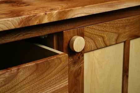 An Elm & Horse Chestnut sideboard showing handle and open drawer