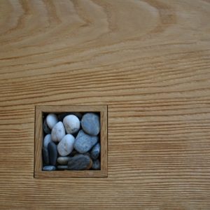 Sea to shore - a coffee table in ash with textured top and inset boxes with sand and pebbles box detail