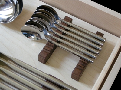 Internal view of knife and spoon drawer in a wine and Cutlery cabinet in sycamore and american walnut